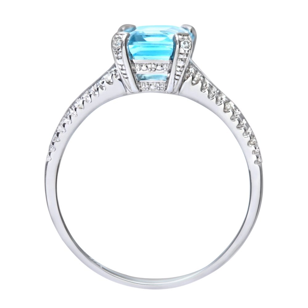 SPARKLD 9ct White Gold Emerald Cut Blue Topaz Ring with 0.07ct Diamond Shoulders