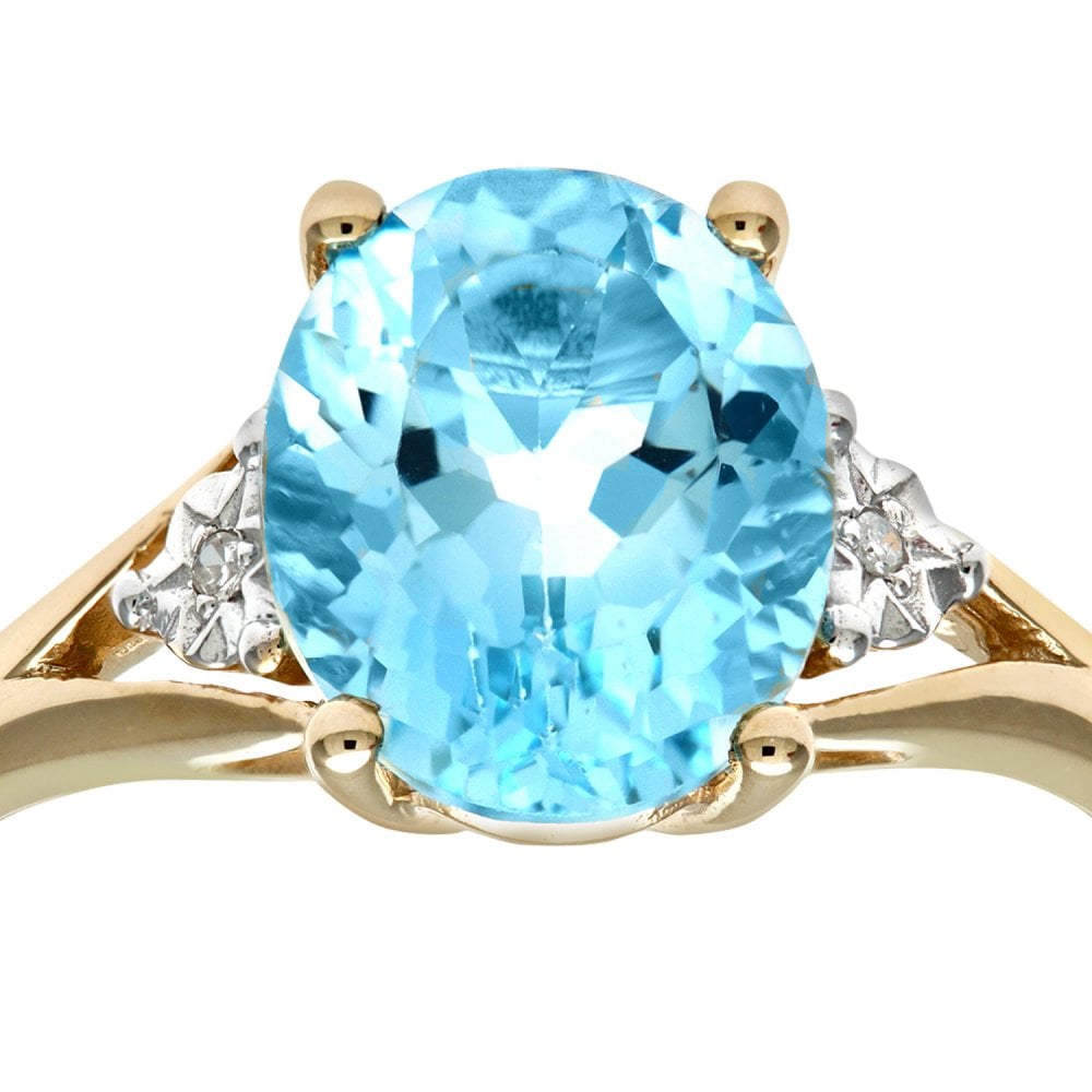 SPARKLD 9ct Yellow Gold Round Brilliant Cut Oval Blue Topaz and 0.01ct Diamond Ring
