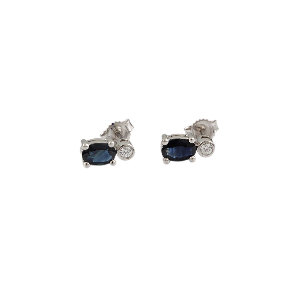 White Gold 0.06ct Round Brilliant Cut Diamond and 1.20ct Oval Blue Sapphire Two Stone Stud Earrings