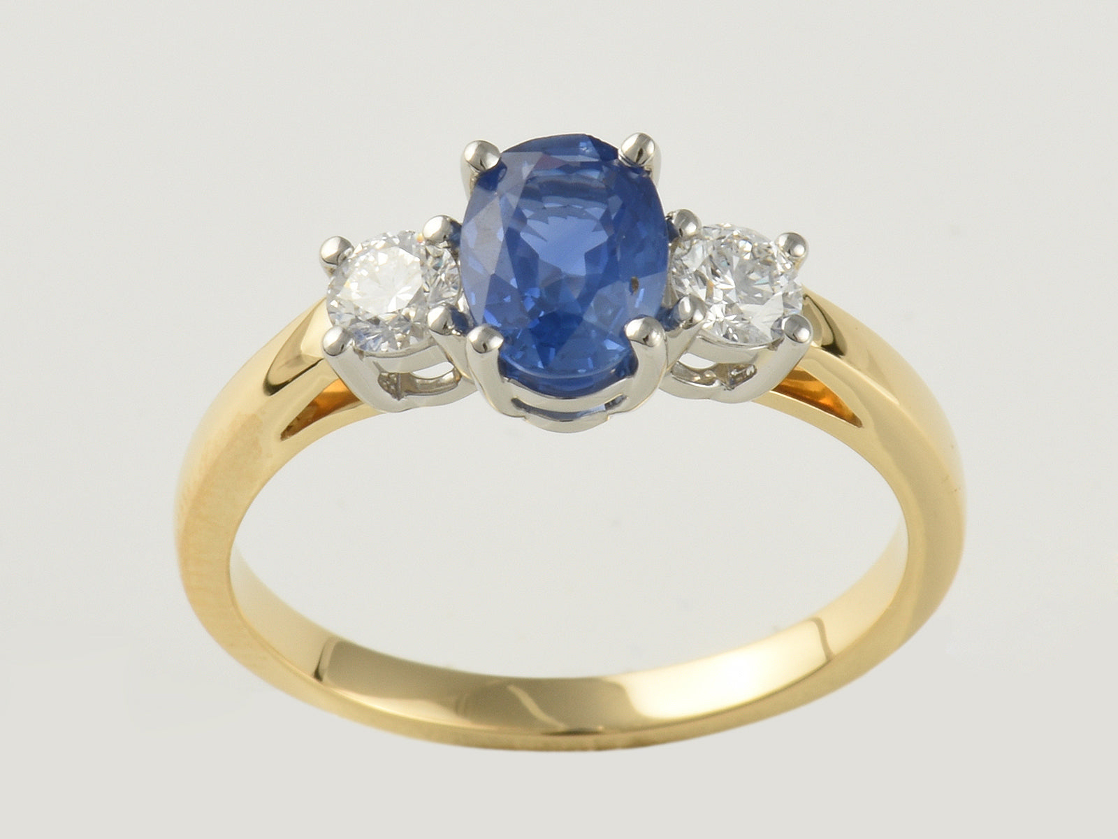 18ct Yellow gold, Platinum Claw Set, Sapphire 1.09ct And Diamond 0.31ct Three Stone Ring.