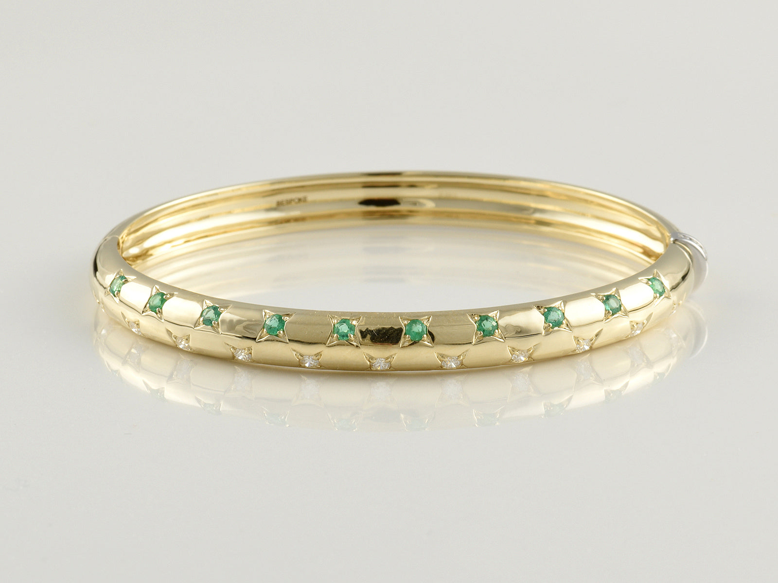 9ct Yellow and White Gold, Claw Set, Emerald 0.42ct and Diamond 0.49ct Hinged Bangle.