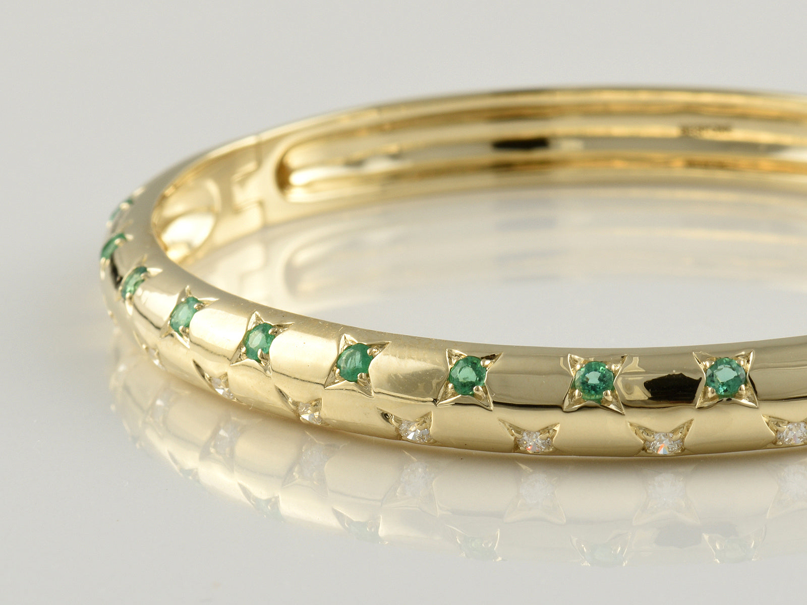 9ct Yellow and White Gold, Claw Set, Emerald 0.42ct and Diamond 0.49ct Hinged Bangle.