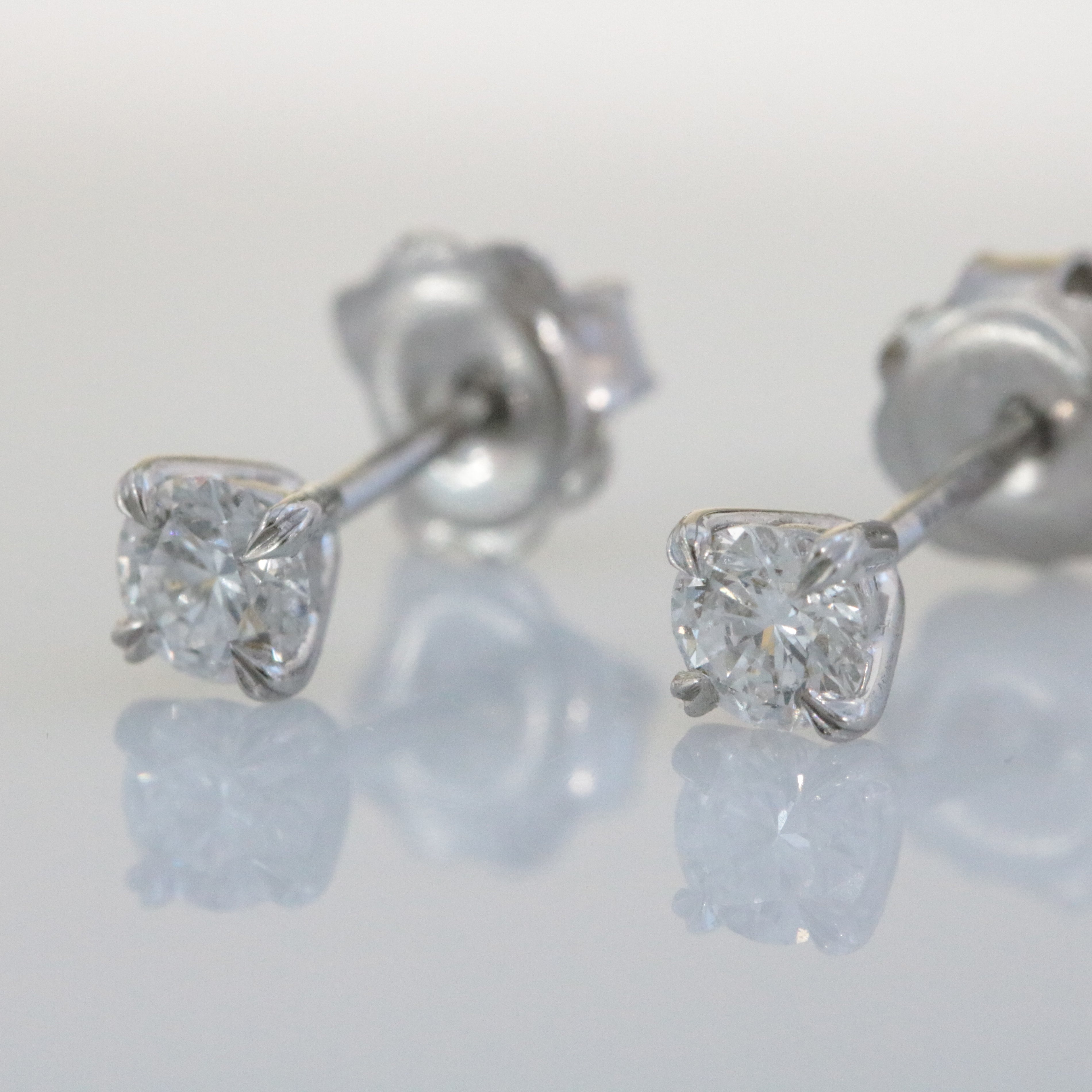 Platinum, Claw Set, GIA Certificated Diamond 0.61ct Solitaire Stud Earrings.