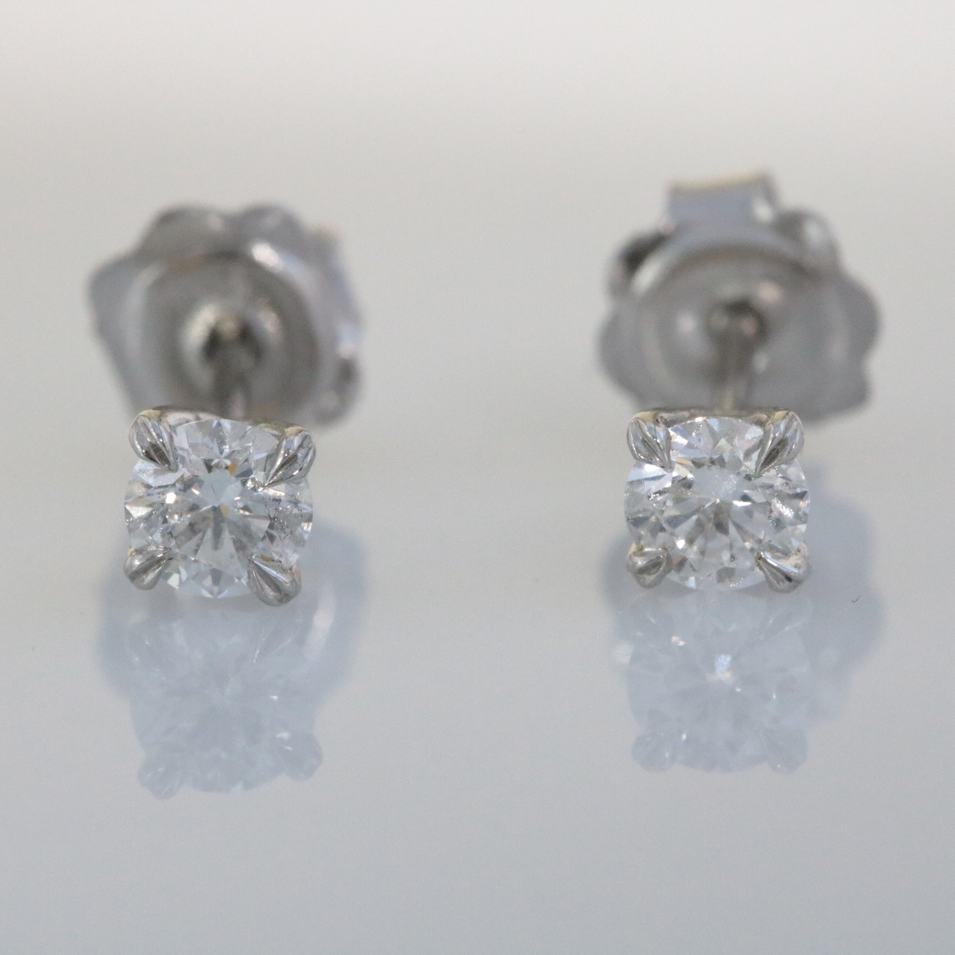 Platinum, Claw Set, GIA Certificated Diamond 0.61ct Solitaire Stud Earrings.